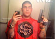 Aaron Hernandez holding a gun