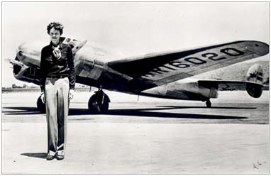 Amelia Earhart posing in front of her Lockheed Electra plane