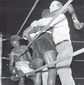 Benny Paret hanging onto referee