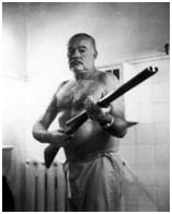 ernest hemmingway holding a shotgun