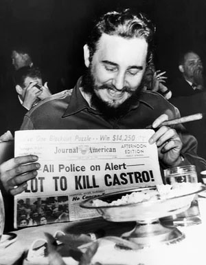 Fidel Castro holding newspaper reporting of plot to kill him