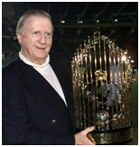 George Steinbrenner holding the world series trophy