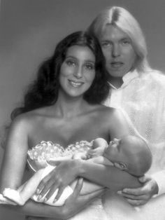 Gregg Allman and Cher holding their son