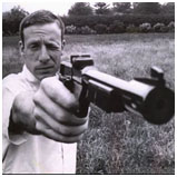 John DuPont pointing a gun