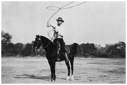 Will Rogers on a horse with a lariat