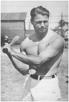 Jimmy Foxx swinging a bat with no shirt on